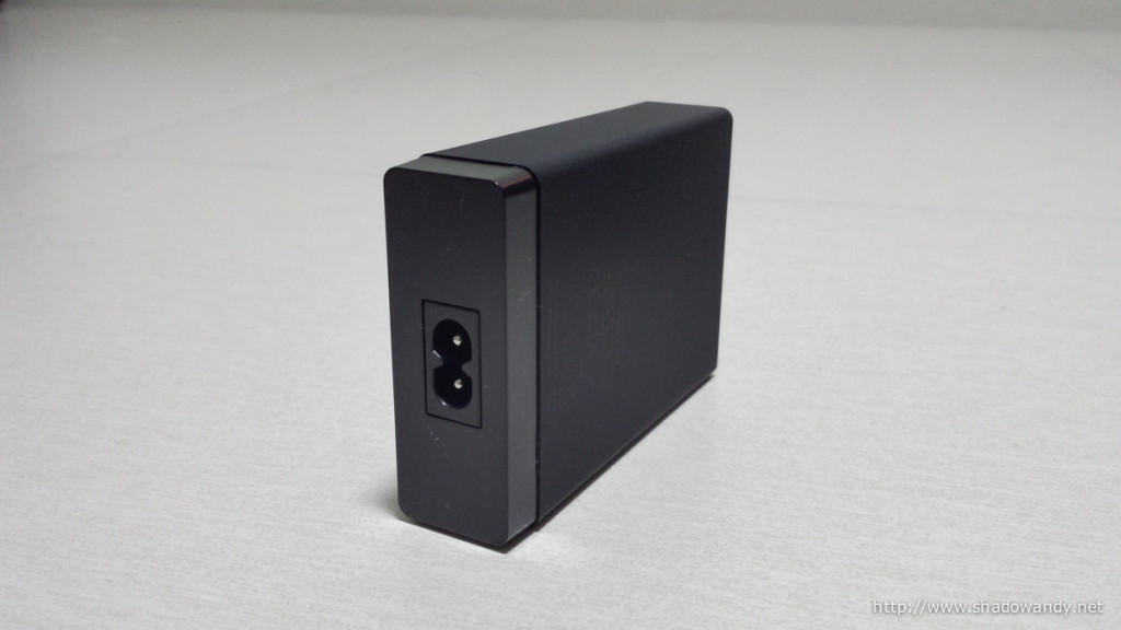 It uses the standard figure-8 power cord. The Anker 60W is 100-240V so you can pretty much use it anywhere