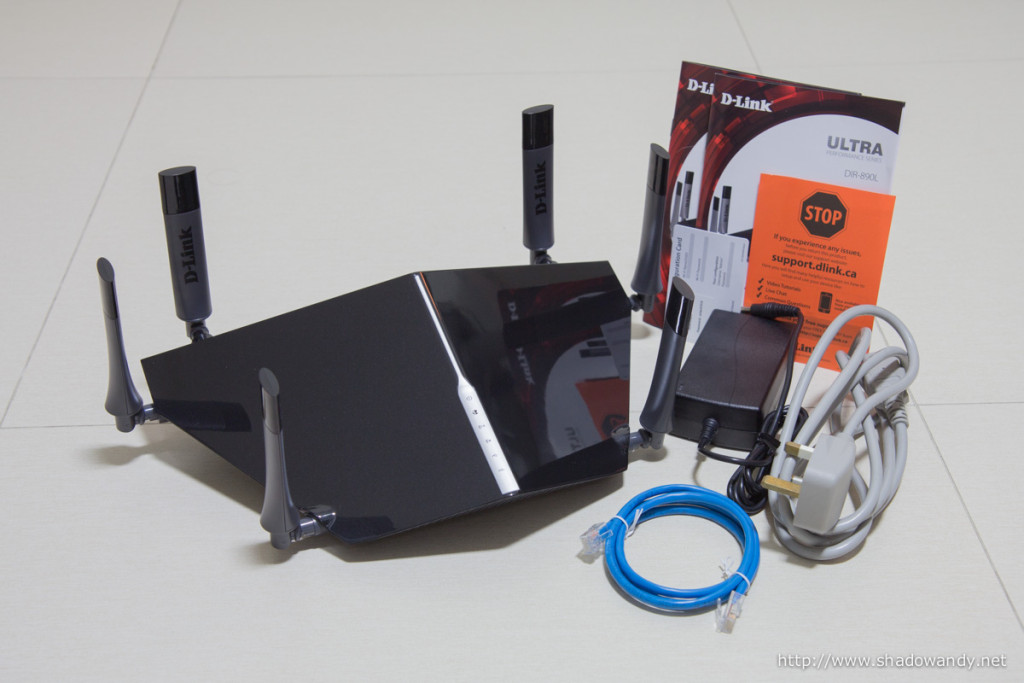 The AC3200 DIR-890L ULTRA router, power adapter, power cord, patch cord, manuals and WiFi configuration card.