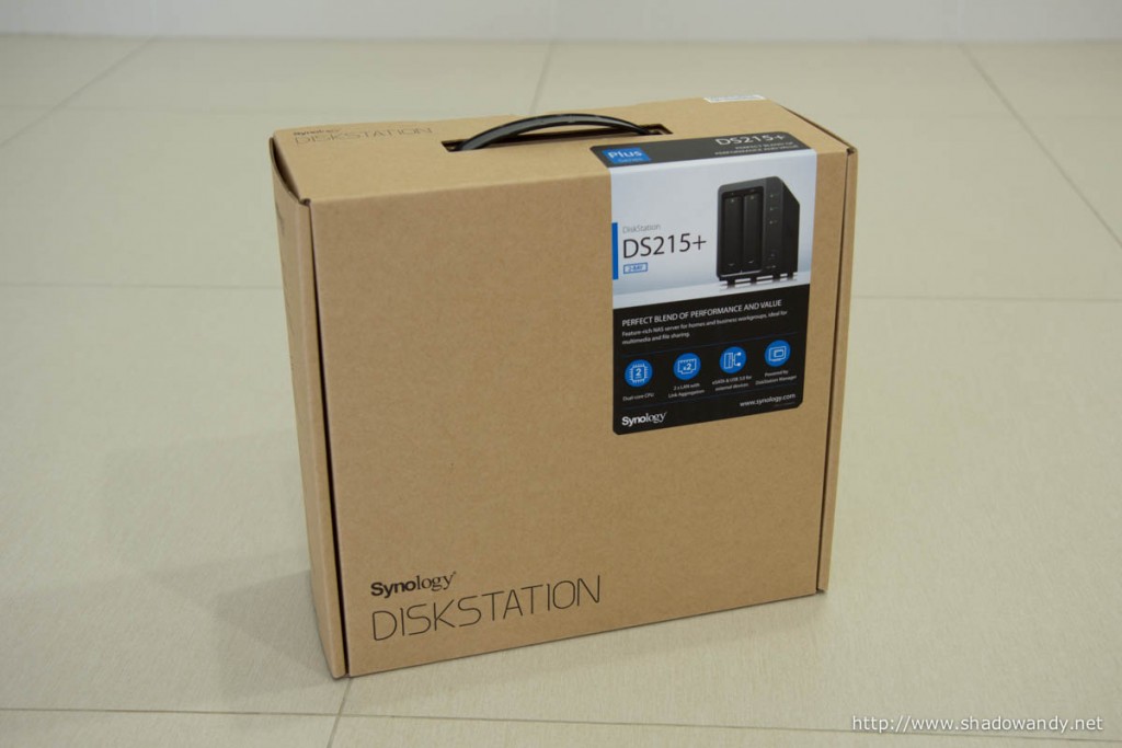 The Synology DS215+ in its usual brown "carton box" packaging.