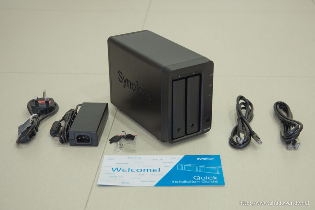 The DS215+ NAS, power cable and adaptor, keys and mounting screws, ethernet patch cords and quick installation guide.