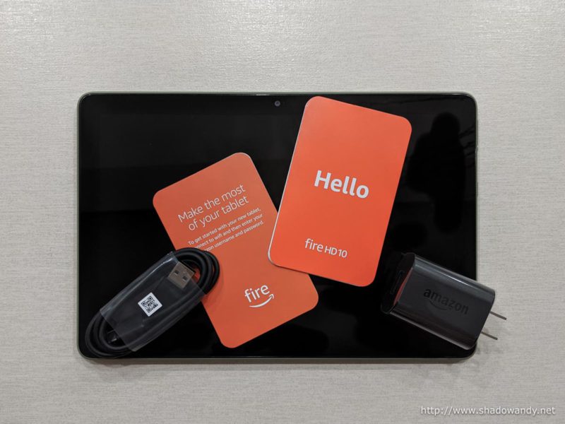 The Fire HD 10 (2021) tablet along with the USB charger, USB-C charging cable and leaflets.