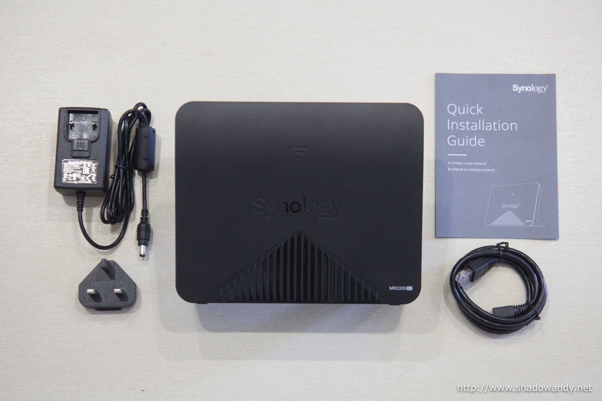 The Synology MR2200ac wireless mesh router, power adapter, Ethernet patch cord and quick installation guide.